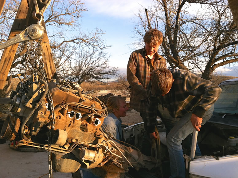 Placing the rebuilt Dodge engine into the Dodge 2500 with a solid frame